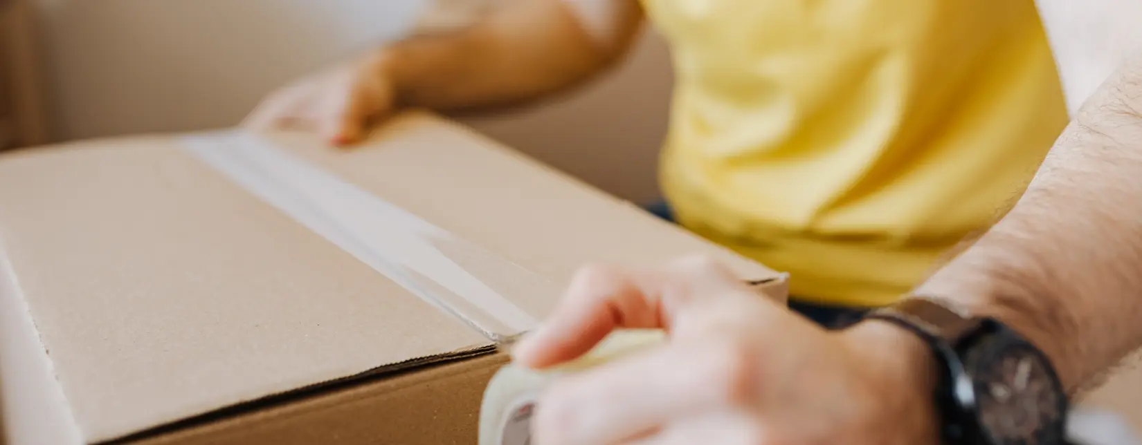 Person packs moving box due to termination of personal use