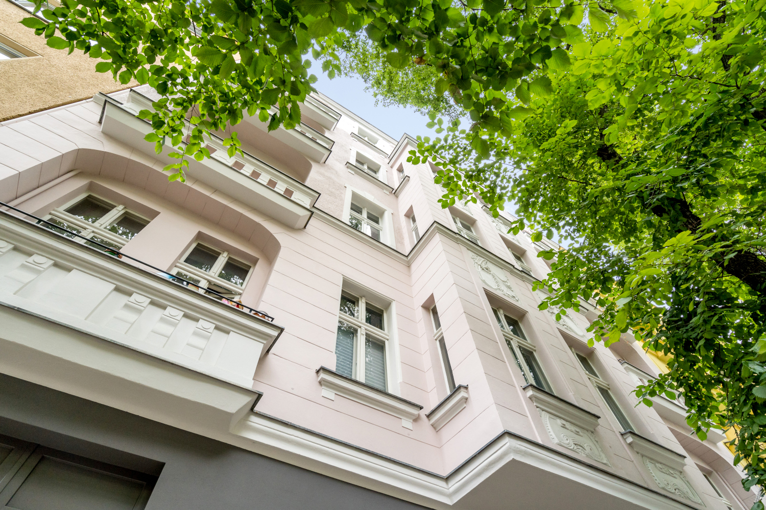 Facade of a renovated old building with modern windows and balconies that preserve the classic style of the building